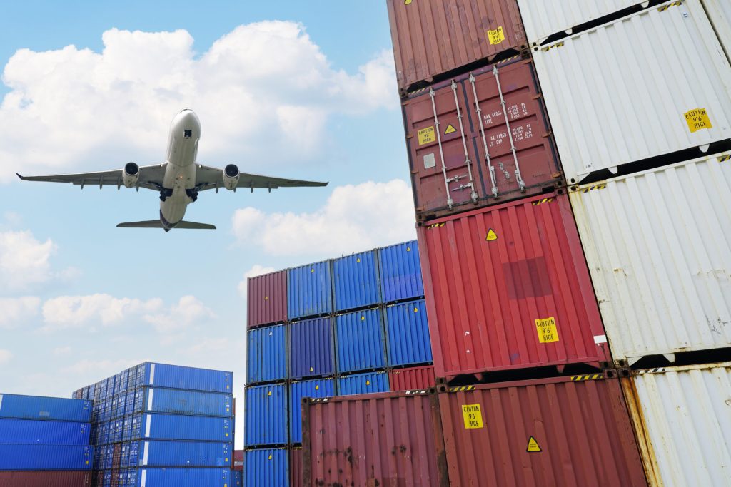 Cargo airplane flying above logistic container. Air logistic. Cargo and shipping business. Container ship for import and export logistic. Logistic industry. Container at harbor. Merchandise export.